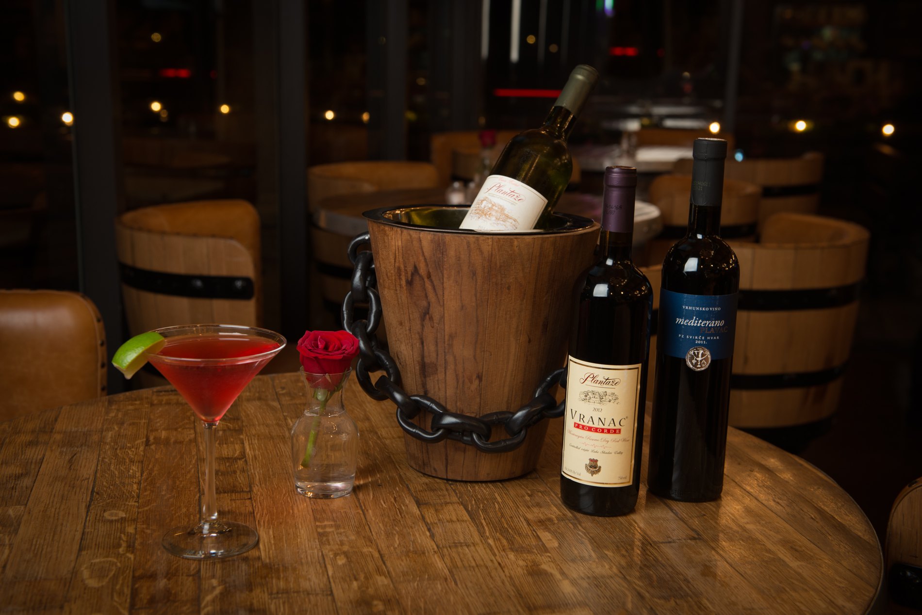 European wines and a cocktail on a wooden table at Alps Village
